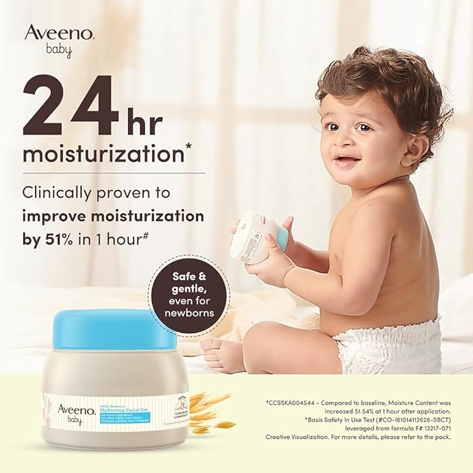 Aveeno baby moisturizer with a child holding a bottle against a neutral background