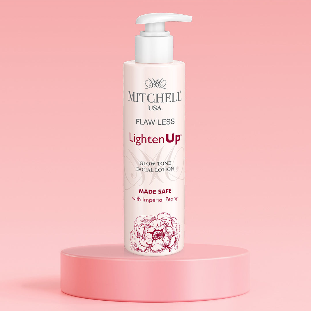 Mitchell USA Flaw-Less Lighten Up facial lotion bottle on a pink platform with a pink background